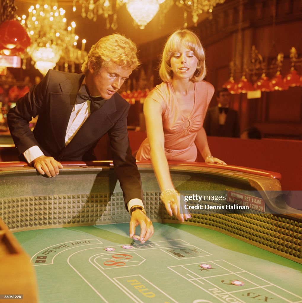 Elegant Couple Gambling at Craps Table