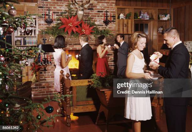 Friends enjoying eggnog and talking at Christmas party