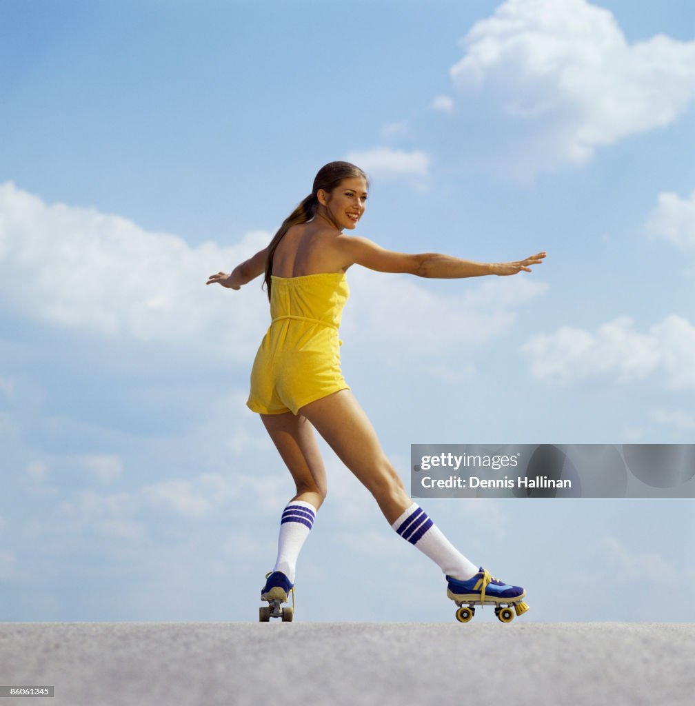 Woman roller-skating wearing jumpsuit