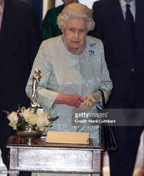 Queen Elizabeth II leaves after a reception to mark the Centenary of the Women's Royal Navy Service and the Women's Auxiliary Army Corp at The Army &...