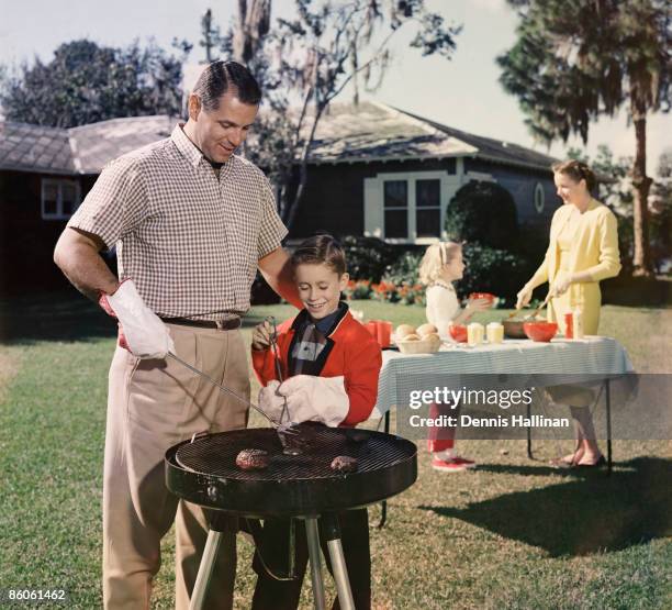 Family grilling in backyard