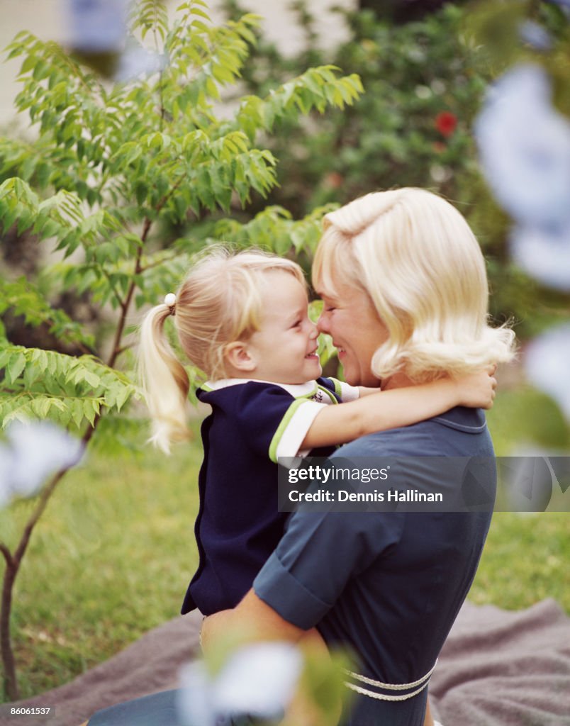 Happy retro mother and daughter rubbing noses