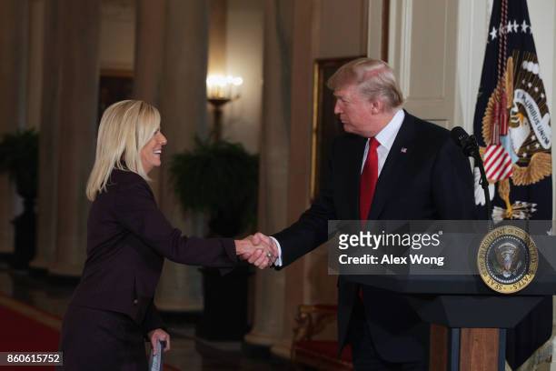 President Donald Trump shakes the hand of White House Deputy Chief of Staff Kirstjen Nielsen during a nomination announcement at the East Room of the...