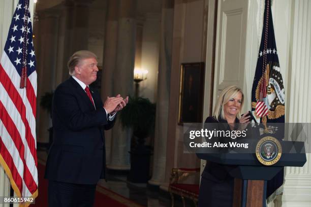 White House Deputy Chief of Staff Kirstjen Nielsen speaks as U.S. President Donald Trump looks on during a nomination announcement at the East Room...
