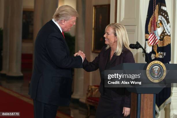 President Donald Trump shakes the hand of White House Deputy Chief of Staff Kirstjen Nielsen during a nomination announcement at the East Room of the...