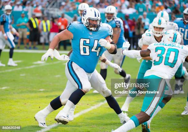 Tennessee Titans Guard Josh Kline runs on the field with Miami Dolphins Cornerback Cordrea Tankersley during an NFL game between the Tennessee Titans...