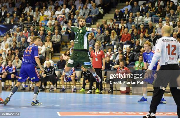 Christoph Steinert of HC Erlangen, Jakov Gojun of Fuechse Berlin, Nicolai Theilinger and Gorazd Skof of HC Erlangen during the game between Fuechse...