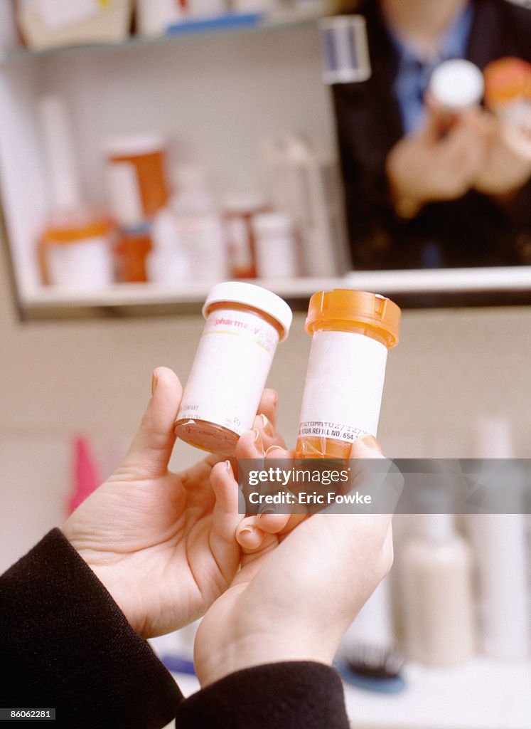 Woman holding pill bottles