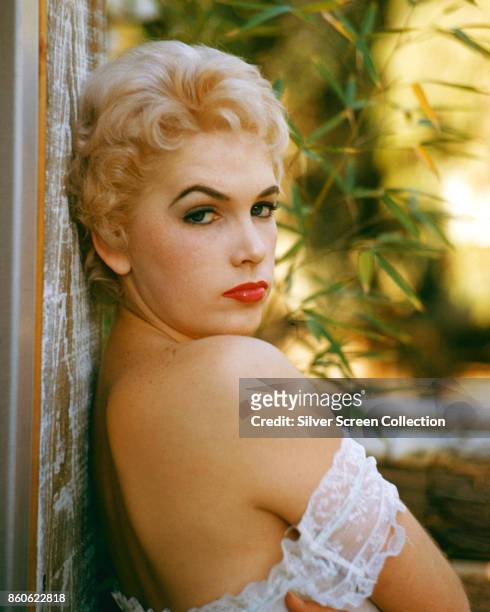 Portrait of American actress Stella Stevens as she looks over her bare shoulder, 1960s.