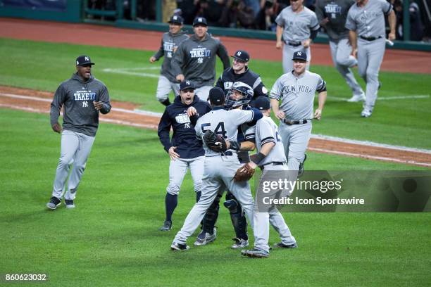 The New York Yankees run on to the field to celebrate following the 2017 American League Divisional Series Game 5 between the New York Yankees and...