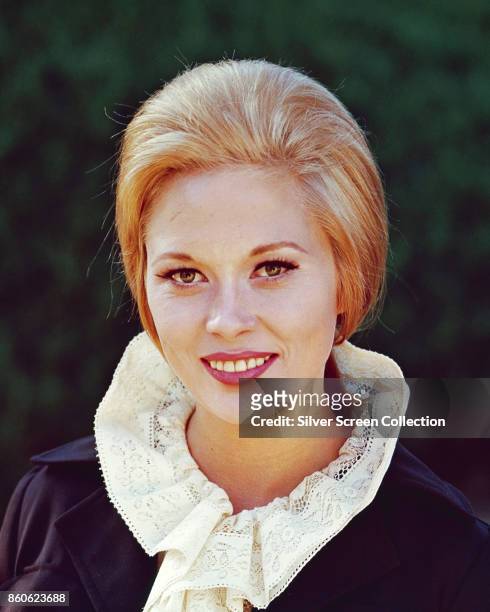 Portrait of American actress Faye Dunaway as she poses outdoors, 1960s or early 1970s.
