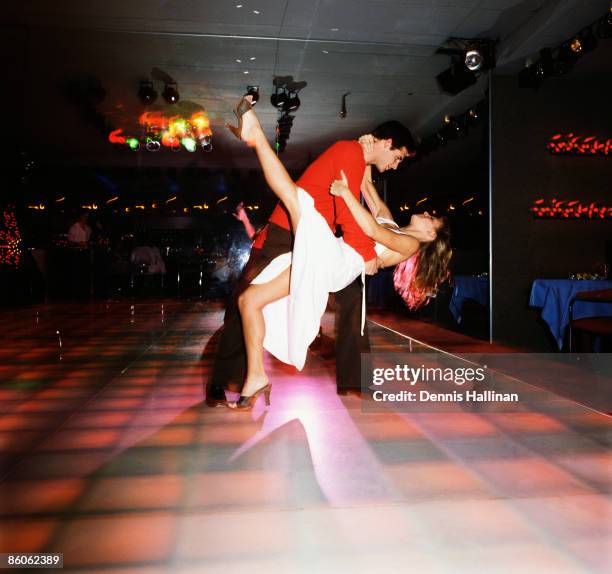 Couple doing disco moves on dance floor