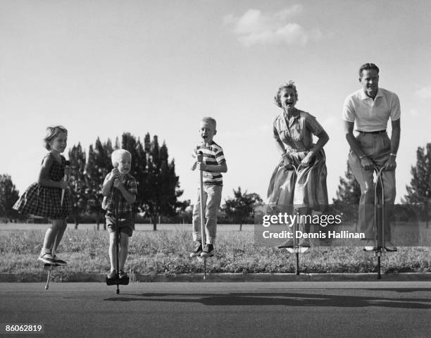 Family Jumping on Pogo Sticks