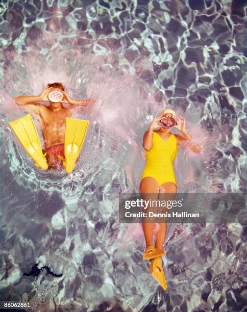Couple diving in swimming pool