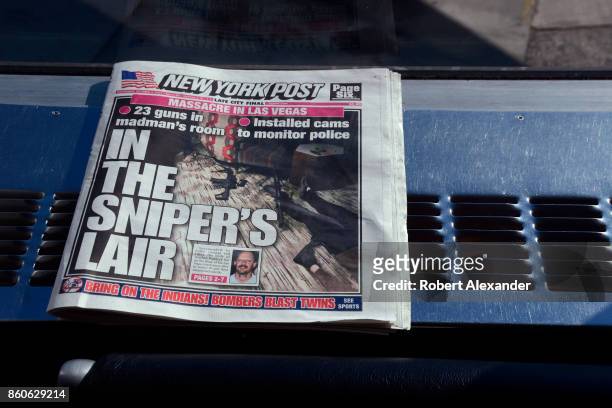 Copy of the New York Post discarded in the terminal at LaGuardia Airport in New York, New York. The headline refers to a mass murder in Las Vegas...