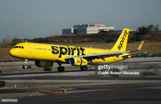 Spirit Airlines passenger jet lands at LaGuardia Airport in New York, New York.