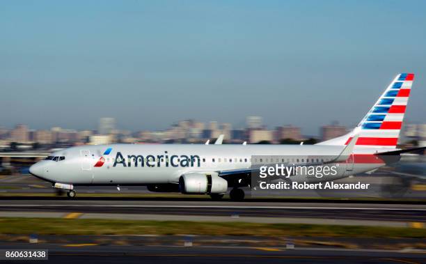 An American Airlines passenger jet lands at LaGuardia Airport in New York, New York.