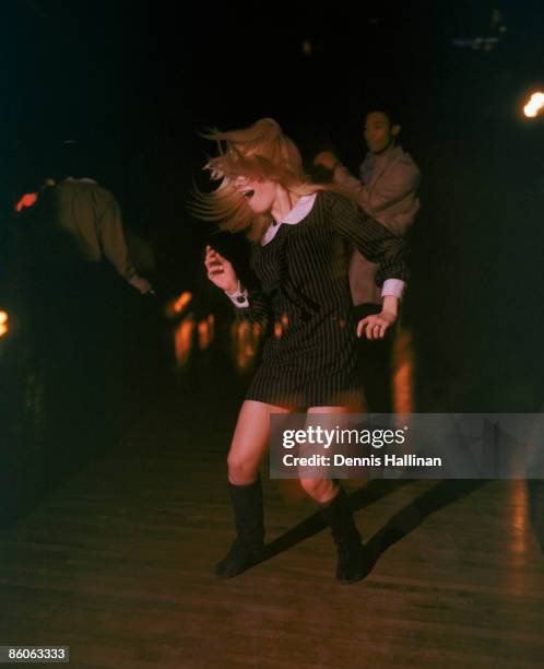 Young woman dances at disco