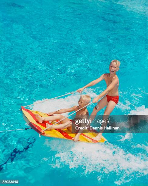 Two Boys Riding on a Water Sled