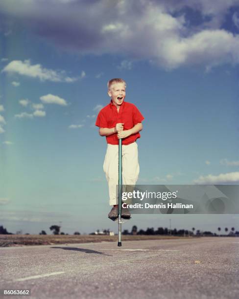 Exuberant Boy Jumping on Pogo Stick