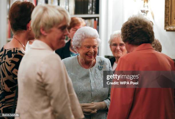 Queen Elizabeth II talks to guests at a reception to celebrate the Women's Royal Naval Service 100 project at The Army and Navy Club on October 12,...