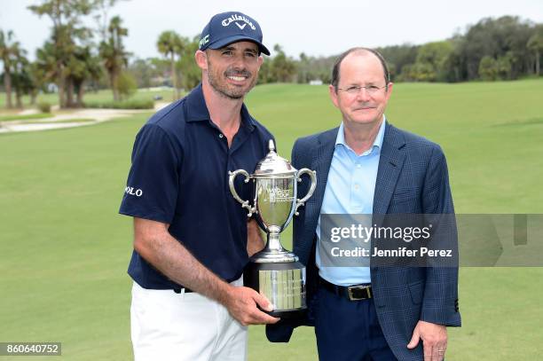 Jonathan Byrd poses with Web.com CEO David Brown and the trophy after the final round of the Web.com Tour Championship at Atlantic Beach Country Club...