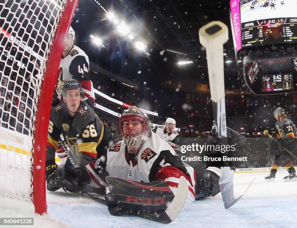 Erik Haula of the Vegas Golden Knights crashes into Louis Domingue of the Arizona Coyotes during the Golden Knights' inaugural regular-season home...