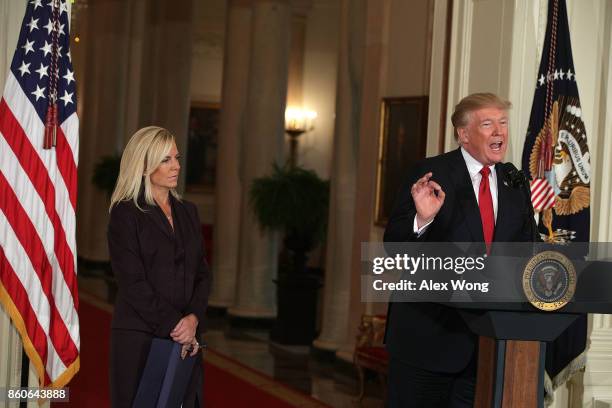 President Donald Trump speaks as White House Deputy Chief of Staff Kirstjen Nielsen looks on during a nomination announcement at the East Room of the...