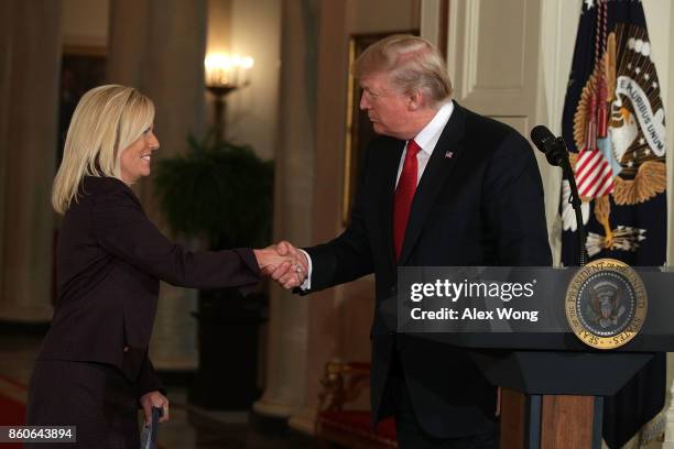 President Donald Trump shakes hands with White House Deputy Chief of Staff Kirstjen Nielsen during a nomination announcement at the East Room of the...