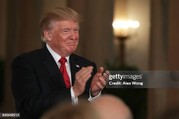 President Donald Trump applauds during a nomination announcement at the East Room of the White House October 12, 2017 in Washington, DC. President...
