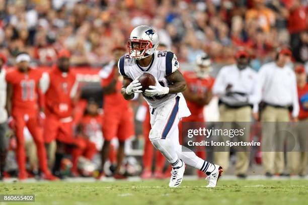 New England Patriots running back James White looks to run after a reception during an NFL football game between the New England Patriots and the...