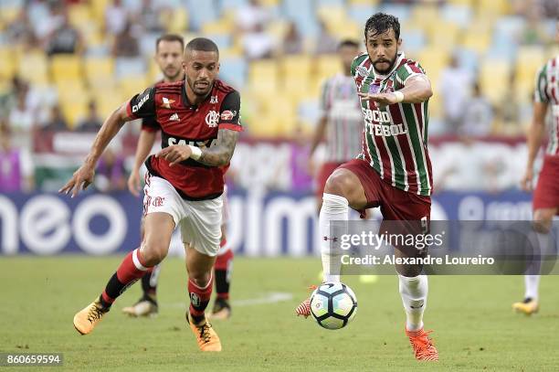 Romulo of Flamengo battles for the ball with Henrique Dourado of Fluminense during the match between Flamengo and Fluminense as part of Brasileirao...