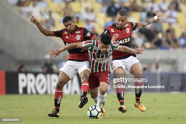 Marcio Araujo and Romulo of Flamengo battles for the ball with Douglas of Fluminense during the match between Flamengo and Fluminense as part of...