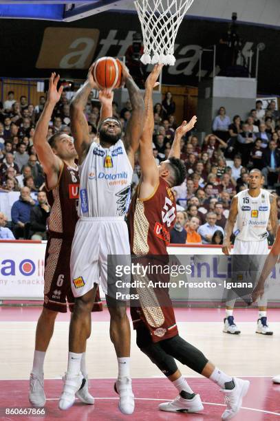 Chane Behanan of Dolomiti Energia competes with Michael Bramos and Mitchell Watt of Umana during the LBA LegaBasket of Serie A1 match between Reyer...