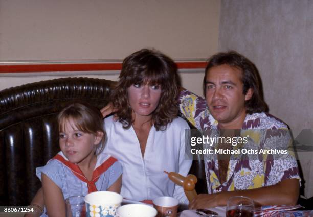 Songwriter Bernie Taupin attends an event with his wife and muse Maxine Feibelman and a young girl in circa 1973.