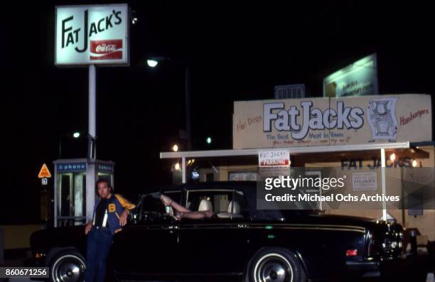 Songwriter Bernie Taupin poses for a portrait with a Rolls Royce car and his wife Toni Lynn Russo outside of Fat Jack's fast food shop on Ventura...