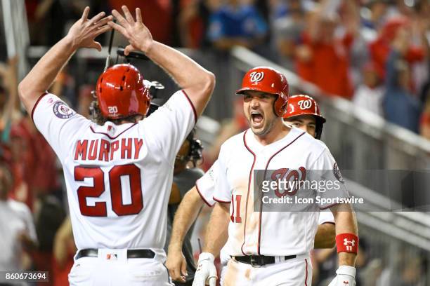Washington Nationals first baseman Ryan Zimmerman yells out with second baseman Daniel Murphy after hitting a game wining 3-run home run in the...