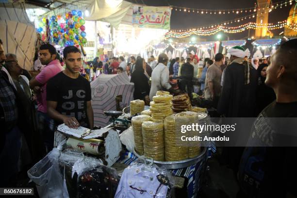 People are shopping as they attend the birthday celebrations of the founder of the Badawiyyah Sufi order Ahmad al-Badawi at Seyyid Al-Badawi Mosque...