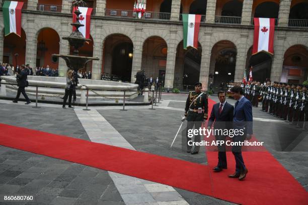 Canada's Prime Minister Justin Trudeau and his Mexican counterpart Enrique Pena Nieto review an honour guard during a welcoming ceremony at the...