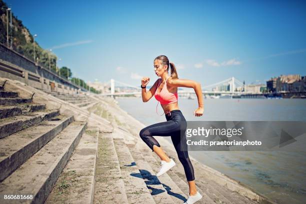 girl is running along the river and climbing a stairs - skinny girl stock pictures, royalty-free photos & images