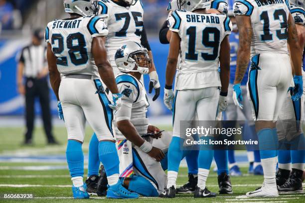 Carolina Panthers quarterback Cam Newton kneels in the huddle while calling a play during game action between the Carolina Panthers and the Detroit...