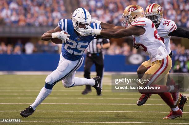 Indianapolis Colts running back Marlon Mack gives a stiff arm to San Francisco 49ers defensive back Jimmie Ward during the NFL game between the San...