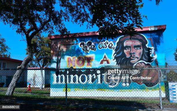 Child runs beside the 1978 painted mural "We Are Not A Minority", a tribute to Cuban revolutionary Che Guevara, in Los Angeles, California, on...