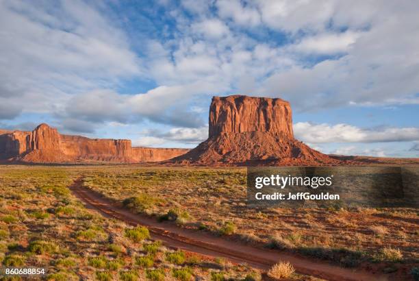 dirt road leading to mitchell butte - kayenta region stock pictures, royalty-free photos & images