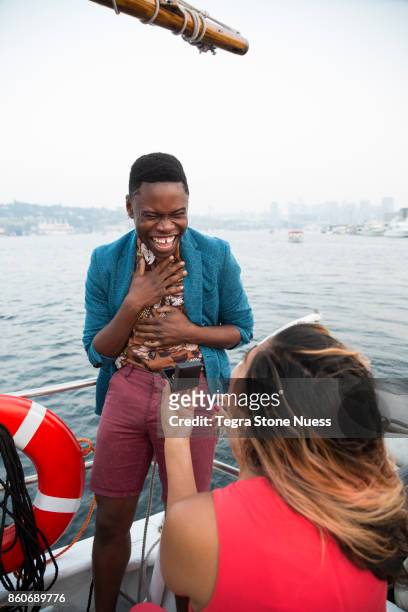 woman proposing to man on sailboat - speaking engagement stock pictures, royalty-free photos & images