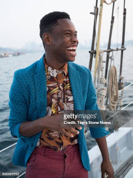 fashionable portrait on sailboat - multi colored jacket stockfoto's en -beelden