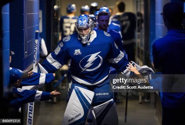 Goalie Andrei Vasilevskiy of the Tampa Bay Lightning is greeted by young fans before the game against the Pittsburgh Penguins at Amalie Arena on...