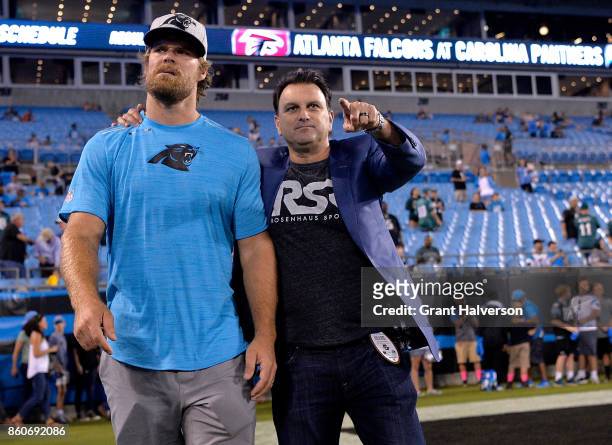 An injured Greg Olsen of the Carolina Panthers walks with his agent, Drew Rosenhaus, before their game against the Philadelphia Eagles at Bank of...
