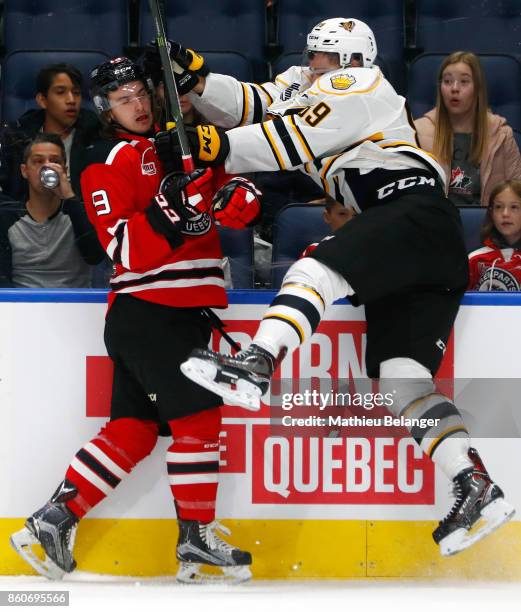 Felix Pare of the Victoriaville Tigres hits Jeremy Laframboise of the Quebec Remparts during the first period of their QMJHL hockey game at the...