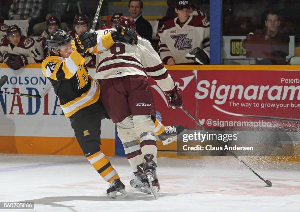 Linus Nyman of the Kingston Frontenacs slams into Auston Osmanski of the Peterborough Petes in an OHL game at the Peterborough Memorial Centre on...